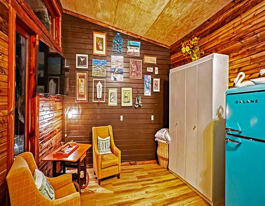 The Bird Nest Vacation Rental Treehouse and Venue, Picayune, MS bungalow treehouse interior closed murphy bed, tv, living area, refrigerator